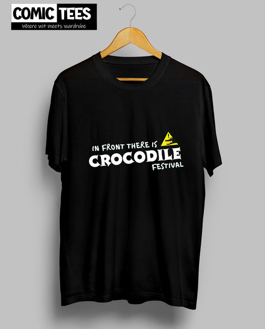 In Front there is a Crocodile Festival T-Shirt